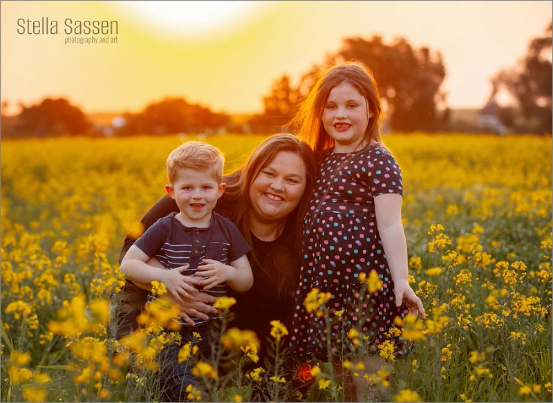 Family photo in the canola fields as the sun sets over the wineland mountains